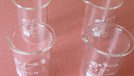 When should I use a glass beaker during ultrasonic cleaning process